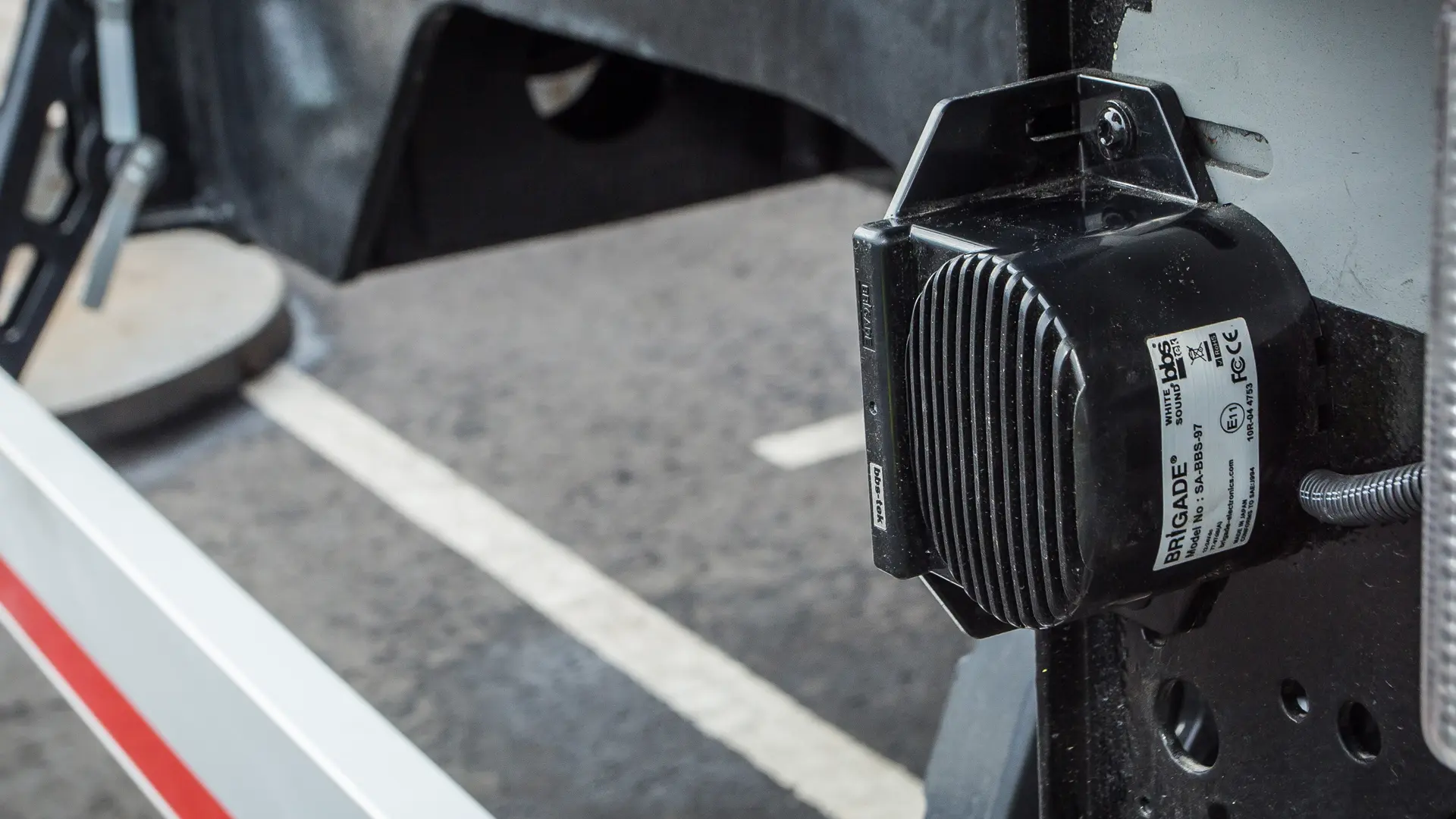 Brigade bbs-tek® white sound medium-duty revering alarm mounted on the rear of a commercial vehicle