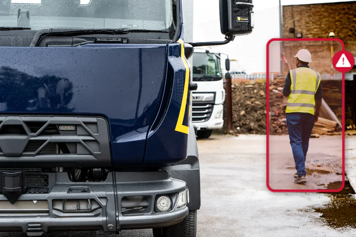 A worker being detected by an AI side camera as they walk in the truck's blind spot.