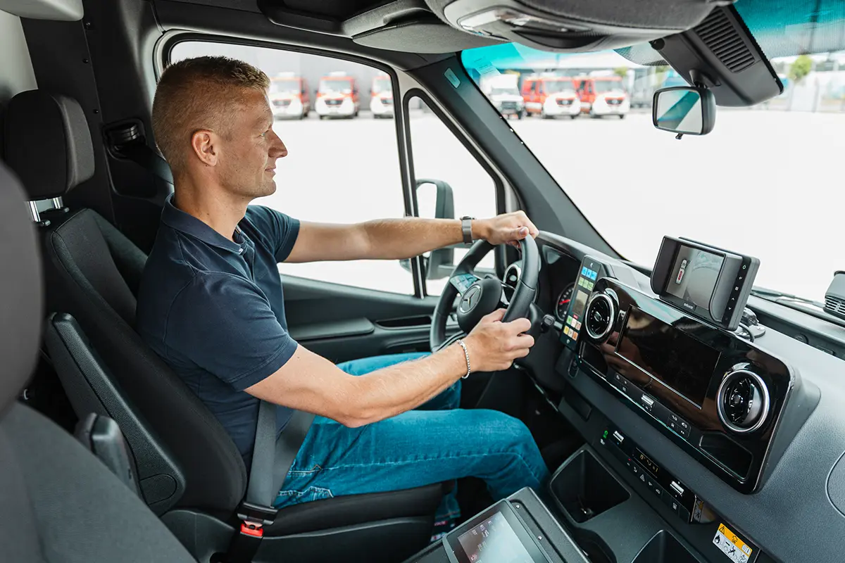 man driving ambulance with Brigade monitor in cab