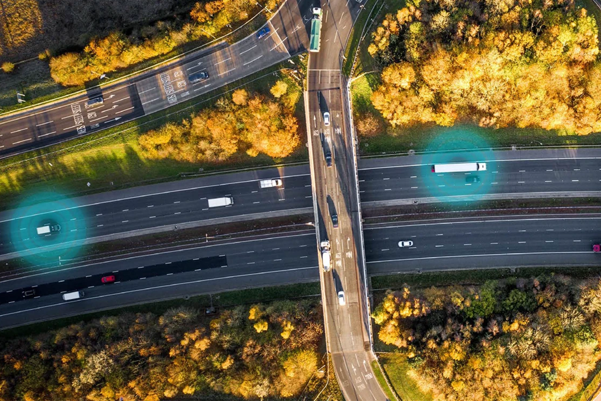 Top down view of motorway/highway where two trucks have brigade protective wave underneath them signifying telematics/fleet management tracking